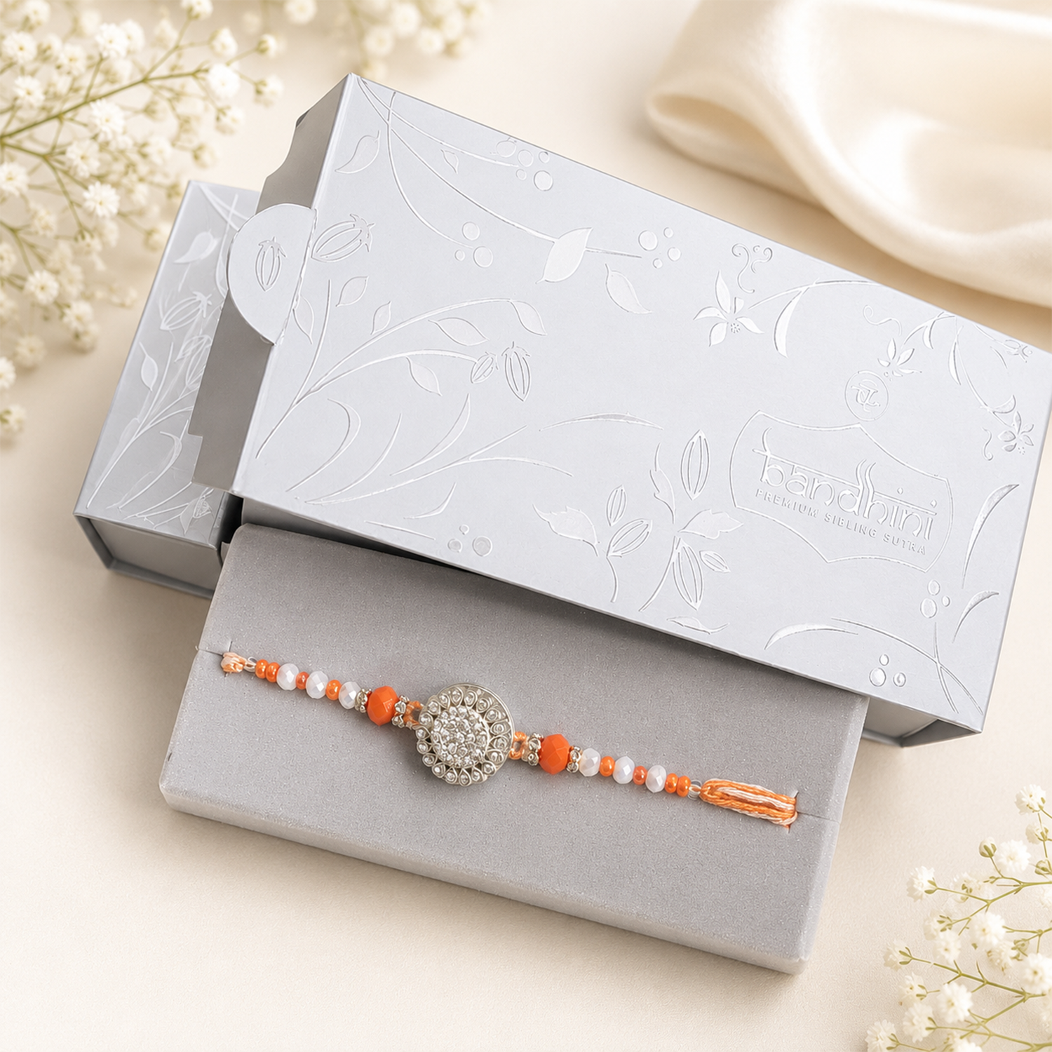Elegant Crystal Floral Rakhi with Orange & White Beads